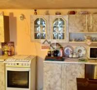 A kitchen in a family house with a kitchen unit and built-in cabinets.