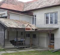 A family house in Studená with a covered terrace and a tiled roof.
