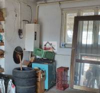 Storage space in a family house with shelves, tires, and electricity.