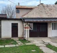 A family house in Studená with a garage, veranda, and traditional roof.