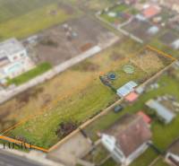 Residential plots in Jahodná with grassy surface and a small structure, suitable for use.