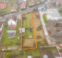 Plots for residential use in Jahodná, depicted includes a yard with a circular pool and a shelter.