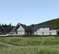 Modern buildings surrounded by nature in development plots near Tajov.