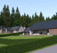 Development plots in Tajov with modern family houses and a forest backdrop.