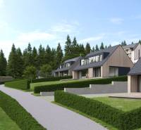 Development plots in Tajov with modern houses surrounded by forest and greenery.