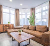 Living room on Hviezdoslavova Street with rustic furniture in a spacious 4-room apartment.
