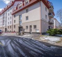Commercial premises on Hviezdoslavova Street in Poprad with a snowy parking lot and building.