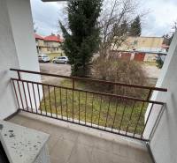 A balcony in a 2-room apartment on Mládeže in Martin with a view of greenery and a parking lot.