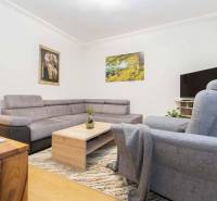 Living room in a two-room apartment with a comfortable sofa and TV.