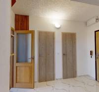 Hallway in a 4-room apartment with light doors and white walls.