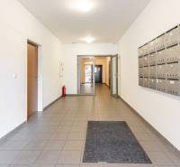 Hallway with mailboxes and tiles in a 2-room apartment.
