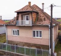 A family house in Nadlice with a balcony, a roof made of clay tiles, and a garden plot.