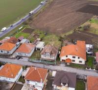 Aerial view of family houses in Nadlice surrounded by agricultural fields and a road.