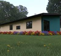 A family house in Spišské Tomášovce, flowers in the garden, simple architecture, grass and trees.