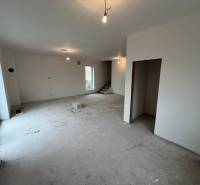 Interior of a family house with an unfinished floor and wall lighting.