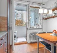Kitchen with dining table, wood-patterned floor, access to balcony, 4-room apartment.