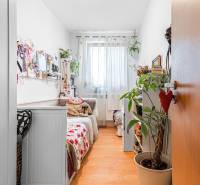 A children's room with light walls, decorations, and a wooden decor floor in a 4-room apartment.