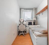 Room in a 4-room apartment with a bed, office chair, and desk.