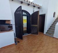 Family house in Villa Martin with a terrace, entrance doors, and a grill.