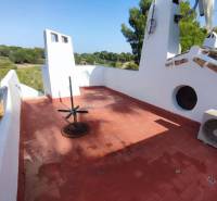 Terrace of a family house in Orihuela Costa with a view and a red floor.