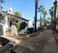 A family house in Orihuela Costa, Villa Martin, surrounded by palm trees, with a terrace and a garden.