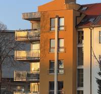 Building on Fazuľová Street in Bratislava - Old Town, with glass balconies and parking.