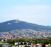 A view of Mount Zobor above Nitra with scattered buildings and greenery.