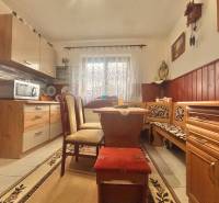 A kitchen in a family house with a corner bench, a microwave, and decorative elements.