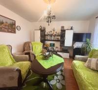 A living room in a family house with furniture and flooring featuring a wooden decor.