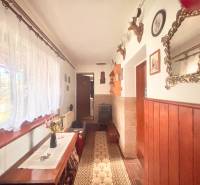 The interior of a family house with hunting trophies, a mirror, and a decorative table.