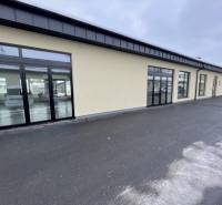 Commercial premises on Jarmočná Street in Stará Ľubovňa with glass display windows and a parking lot.