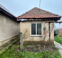 A family house on Bešeňovská Street in Dvory nad Žitavou with an older roof and a garden.
