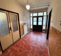 Hallway in a family house with a colorful floor and large glass doors.