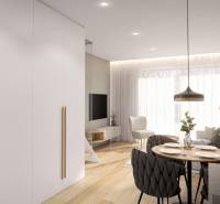 A recreational apartment with a wood-patterned floor, a dining table, and comfortable seating.