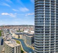 View of Bratislava from Pribinova with the river, modern buildings, and a 4-room apartment.