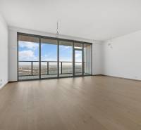 A spacious living room in a 3-room apartment with glass doors and a wooden decor floor.