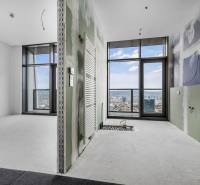 Unfinished interior of a 4-room apartment with large windows and a view of the city.