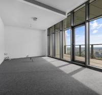 A room with large windows and a view from a 4-room apartment, covered with carpet.