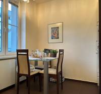 Dining area with two chairs and a table in a 2-room apartment.