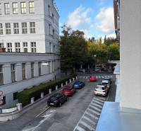 Street in Bratislava - Old Town, Cukrová with cars and a building on the edge of a 2-room apartment.