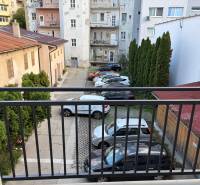 Parking lot with cars and greenery on Cukrová Street in Bratislava - Old Town.