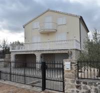 A family house in the town of Pridraga with a stone facade, garden, and balcony.