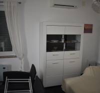 Living room with white furniture, sofa, and air conditioning in a family house.