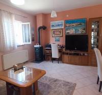 Living room in a family house with decorative paintings and furniture in warm colors.