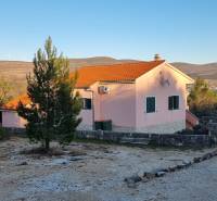 A family house in Pridraga near the coast, surrounded by nature and countryside with wind turbines.