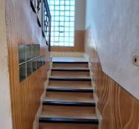A staircase with a tiled floor in a family house.