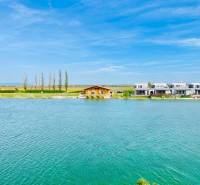 Lake in Senec with modern architecture on residential plots.