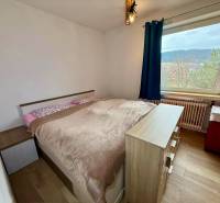 A bedroom in a family house with a bed and a wooden decor floor.