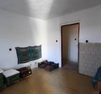 A room in a family house with white walls and storage in plastic crates.