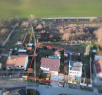 A family house on Suchovská Street in Šelpice surrounded by a garden and neighboring houses.